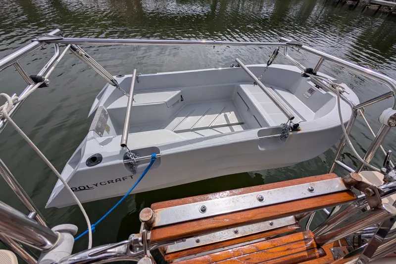 Lone Star Yacht Photos Pics Small Polycraft boat docked beside 1988 Island Packet 38 yacht.