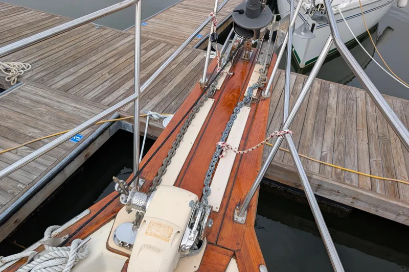 Lone Star Yacht Photos Pics Bow of 1988 Island Packet 38 sailboat docked, featuring anchor chain and wooden deck.