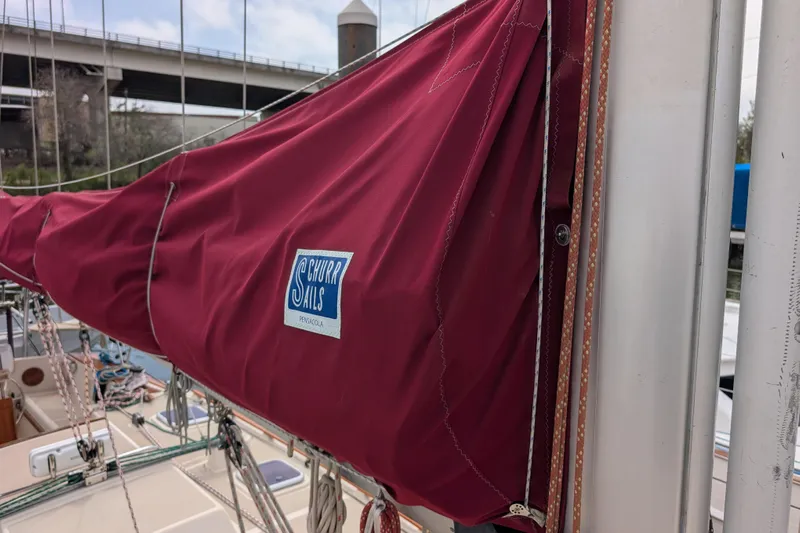 Lone Star Yacht Photos Pics Red sail cover on 1988 Island Packet 38 sailboat, featuring Churr Sails logo.