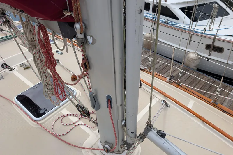 Lone Star Yacht Photos Pics 1988 Island Packet 38 sailboat deck with mast, ropes, and docked yacht in background.