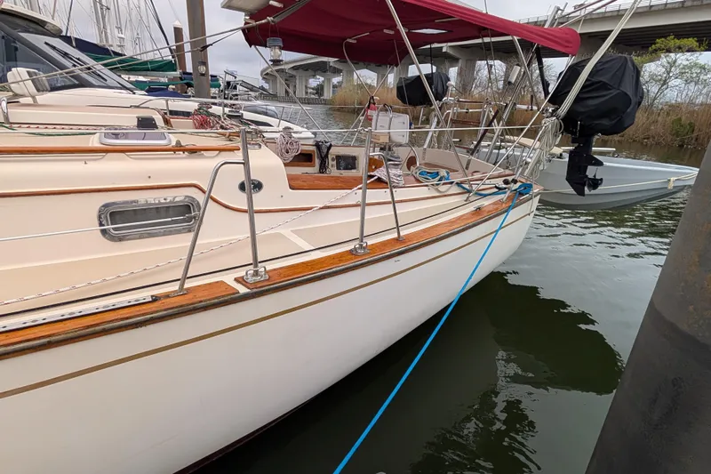 Lone Star Yacht Photos Pics 1988 Island Packet 38 sailboat docked with red canopy and polished wood accents.