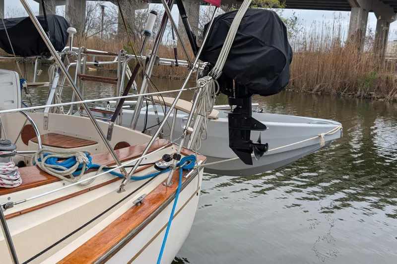 Lone Star Yacht Photos Pics 1988 Island Packet 38 sailboat docked with ropes and motor, under a bridge.