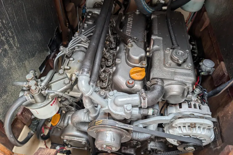 Lone Star Yacht Photos Pics Engine of a 1988 Island Packet 38 sailboat, showcasing mechanical components and Yanmar filter.