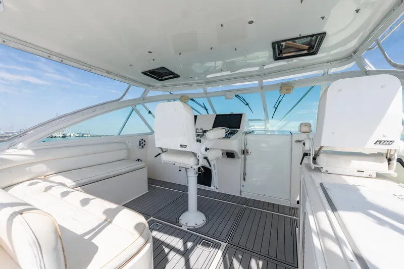 Yacht Photos Pics 2004 Cabo 40 Express yacht interior with helm, seating, and ocean view.