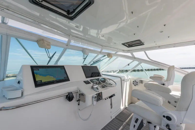  Yacht Photos Pics 2004 Cabo 40 Express yacht cockpit with navigation equipment and ocean view.