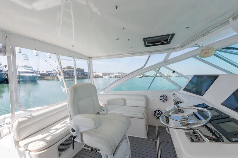  Yacht Photos Pics Interior of 2004 Cabo 40 Express yacht with helm station and marina view.