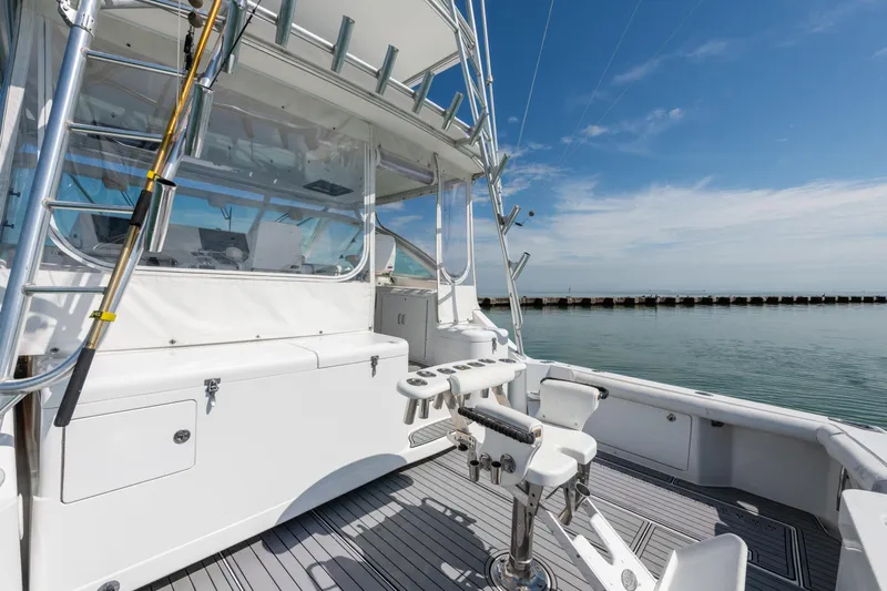  Yacht Photos Pics 2004 Cabo 40 Express yacht deck with fishing chair and ocean view.