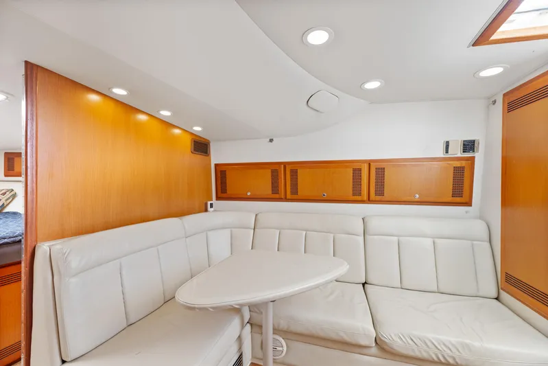  Yacht Photos Pics Luxurious interior of 2004 Cabo 40 Express yacht with white leather seating and wooden accents.