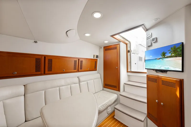  Yacht Photos Pics Luxurious interior of 2004 Cabo 40 Express yacht with white seating and wooden accents.