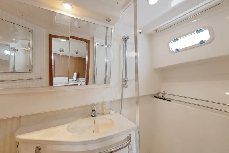  Yacht Photos Pics Luxurious bathroom in 2004 Cabo 40 Express yacht with modern fixtures and elegant design.