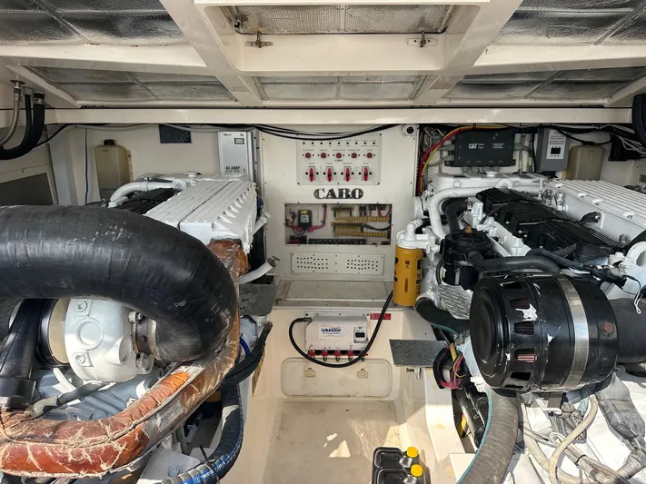 Yacht Photos Pics Engine room of a 2004 Cabo 40 Express boat, showcasing dual engines and control systems.