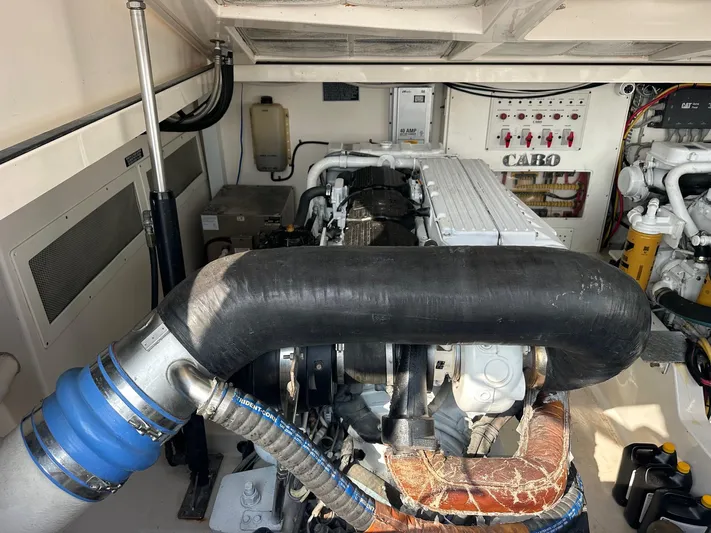  Yacht Photos Pics Engine room of a 2004 Cabo 40 Express boat, showcasing mechanical components and systems.