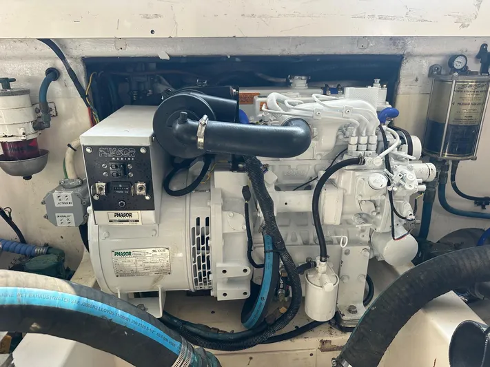  Yacht Photos Pics Engine compartment of a 2004 Cabo 40 Express boat, featuring a generator and various components.