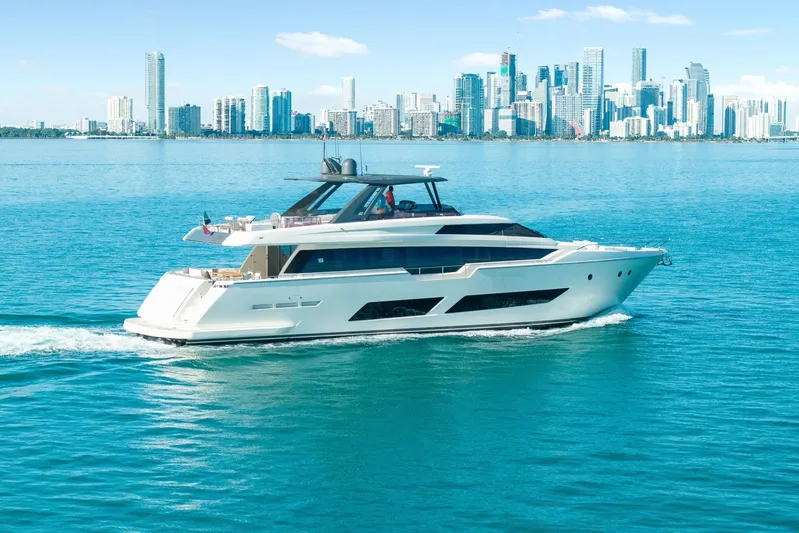 Vix Yacht Photos Pics Luxurious 2018 Ferretti Yachts 850 cruising near a city skyline on a sunny day.