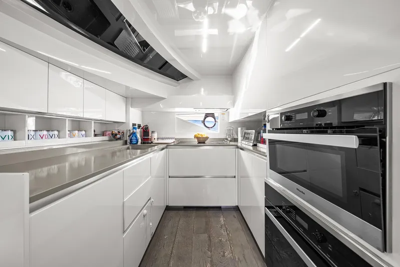 Vix Yacht Photos Pics Modern kitchen interior in 2018 Ferretti Yachts 850, featuring sleek white cabinetry and appliances.