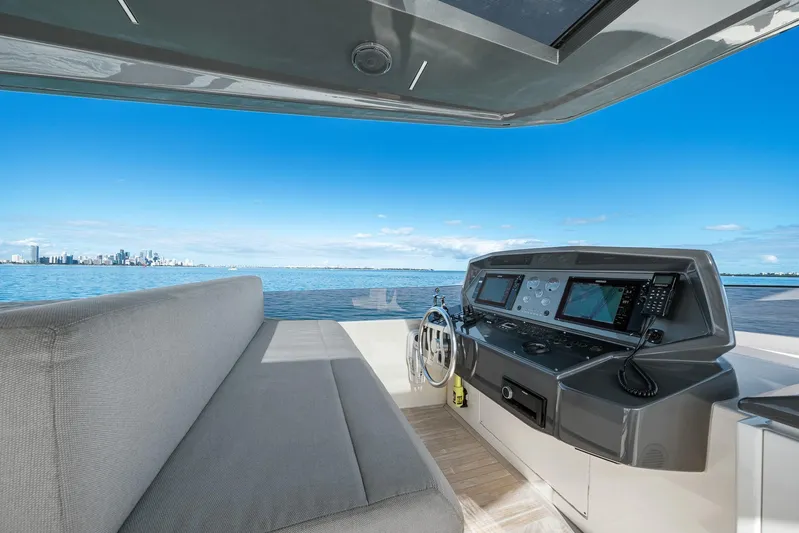 Vix Yacht Photos Pics Helm of 2018 Ferretti Yachts 850 with city skyline view.