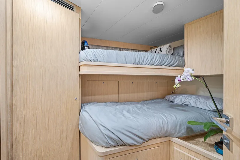 Vix Yacht Photos Pics Bunk beds in 2018 Ferretti Yachts 850 cabin with light wood finish and orchid decoration.