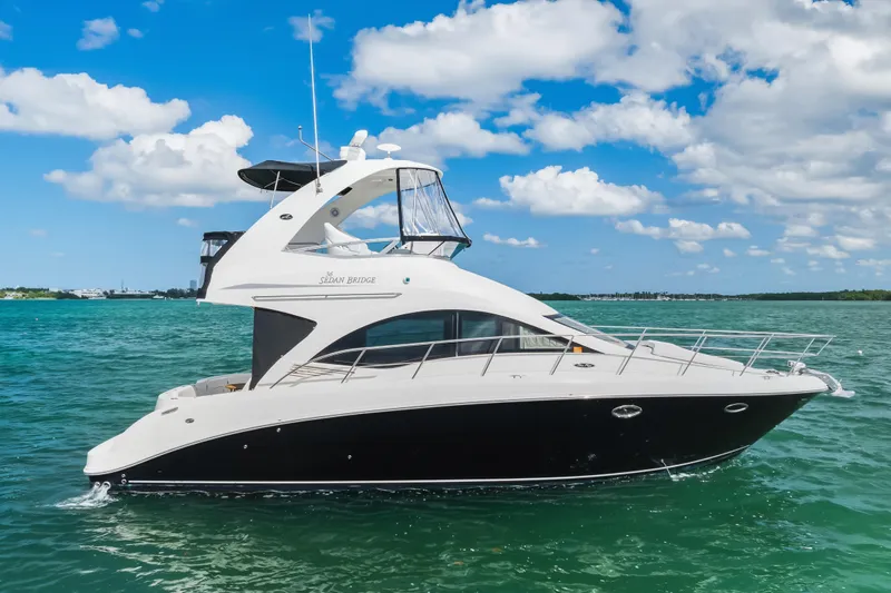 Deep Blue Yacht Photos Pics 2008 Sea Ray 36 Sedan Bridge yacht cruising on clear blue waters under a sunny sky.