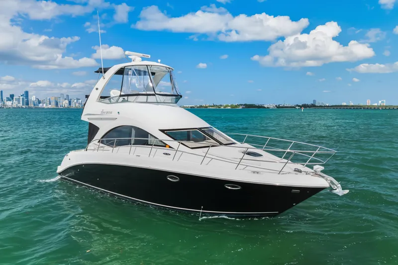Deep Blue Yacht Photos Pics 2008 Sea Ray 36 Sedan Bridge yacht cruising on clear blue waters under a sunny sky.