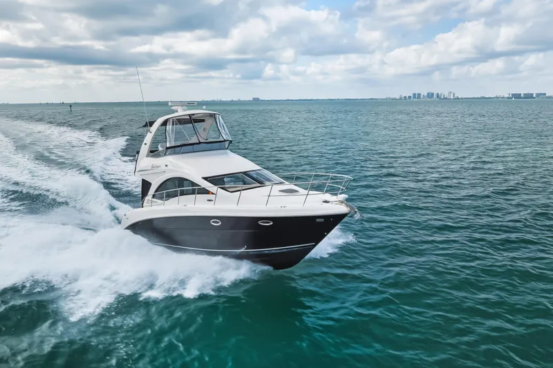 Deep Blue Yacht Photos Pics 2008 Sea Ray 36 Sedan Bridge cruising on open water under a cloudy sky.