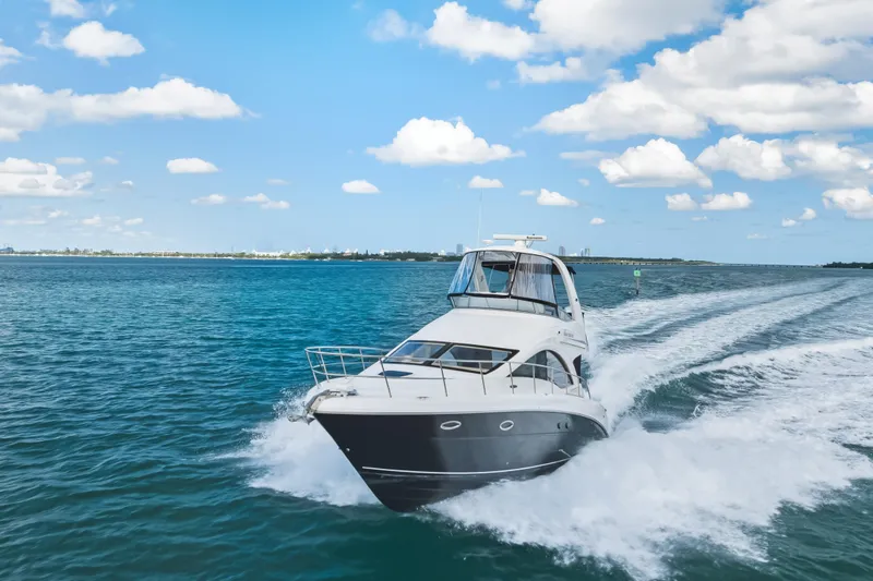Deep Blue Yacht Photos Pics 2008 Sea Ray 36 Sedan Bridge cruising on open water under a clear blue sky.
