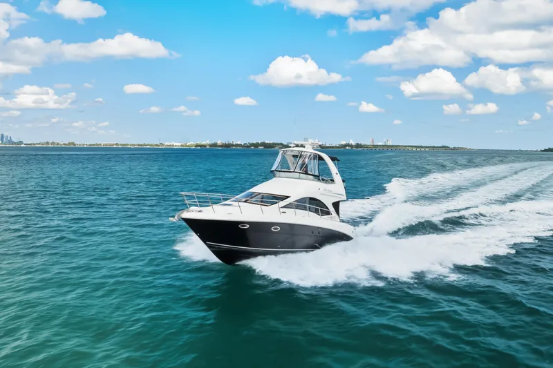 Deep Blue Yacht Photos Pics 2008 Sea Ray 36 Sedan Bridge cruising on open water under a clear blue sky.