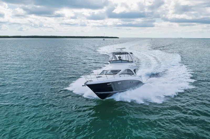 Deep Blue Yacht Photos Pics 2008 Sea Ray 36 Sedan Bridge cruising on open water under cloudy skies.