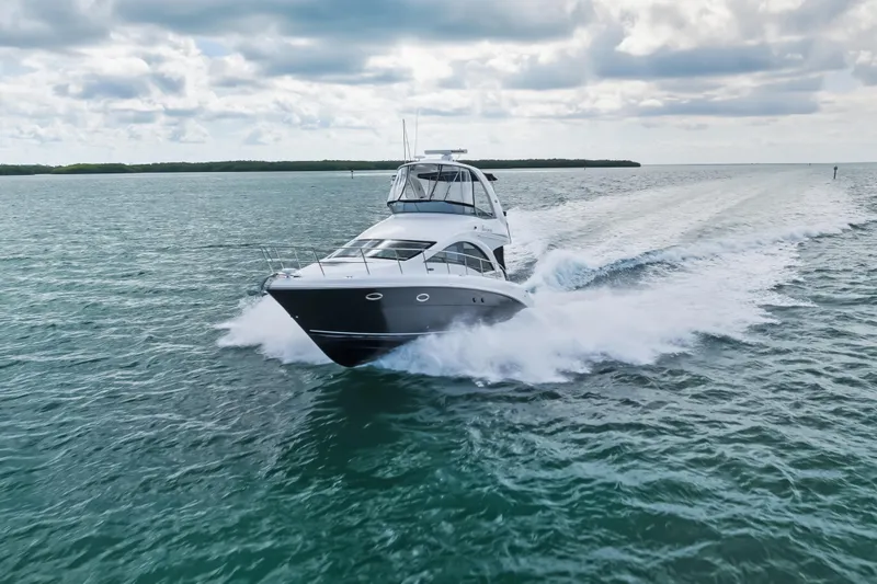 Deep Blue Yacht Photos Pics 2008 Sea Ray 36 Sedan Bridge cruising on open water under cloudy skies.