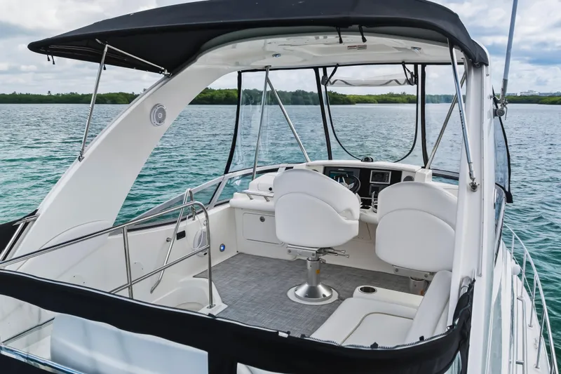 Deep Blue Yacht Photos Pics 2008 Sea Ray 36 Sedan Bridge yacht interior with helm, white seating, and ocean view.