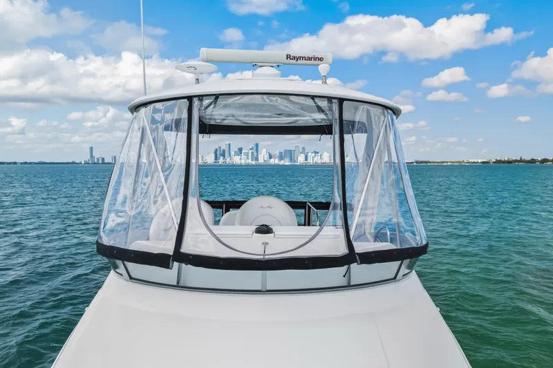 Deep Blue Yacht Photos Pics 2008 Sea Ray 36 Sedan Bridge yacht on blue ocean with city skyline.