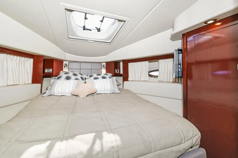 Deep Blue Yacht Photos Pics Luxurious cabin interior of 2008 Sea Ray 36 Sedan Bridge yacht with skylight and cozy bedding.