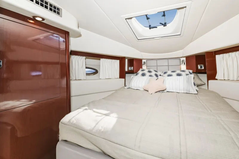 Deep Blue Yacht Photos Pics Luxurious cabin interior of 2008 Sea Ray 36 Sedan Bridge yacht with skylight and plush bedding.