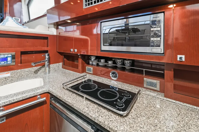 Deep Blue Yacht Photos Pics Luxurious 2008 Sea Ray 36 Sedan Bridge yacht kitchen with modern appliances and sleek design.