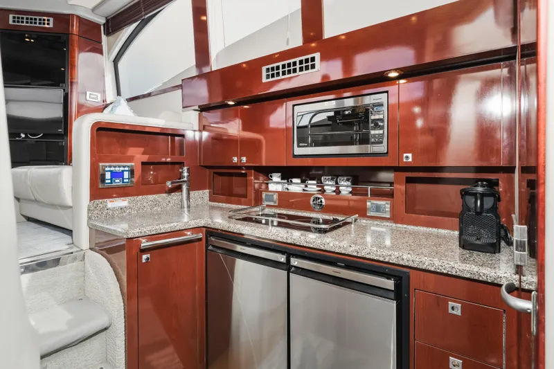 Deep Blue Yacht Photos Pics Luxurious 2008 Sea Ray 36 Sedan Bridge yacht kitchen with modern appliances and sleek design.