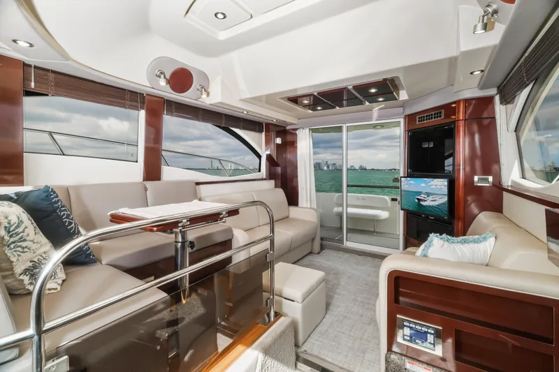 Deep Blue Yacht Photos Pics Luxurious interior of 2008 Sea Ray 36 Sedan Bridge yacht with elegant seating and scenic ocean view.