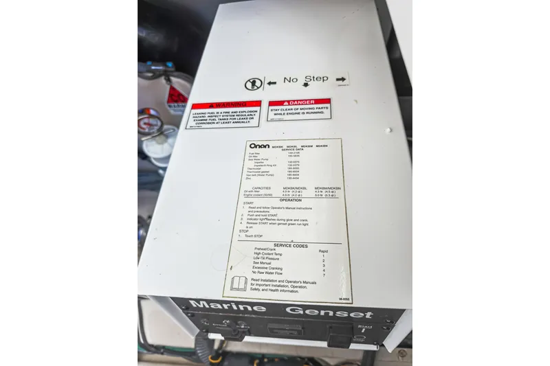 Deep Blue Yacht Photos Pics Marine generator on a 2008 Sea Ray 36 Sedan Bridge, featuring safety and operation labels.