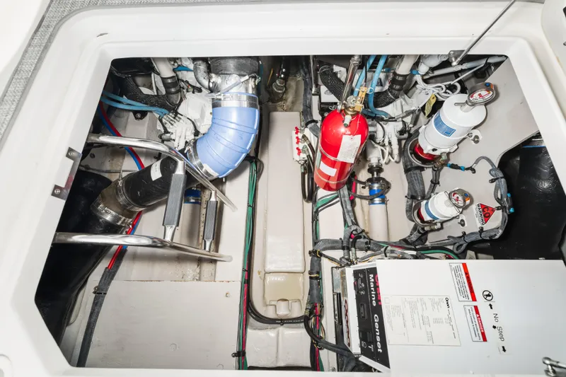 Deep Blue Yacht Photos Pics Engine compartment of a 2008 Sea Ray 36 Sedan Bridge, featuring mechanical components and fire extinguisher.