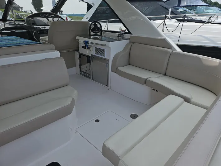  Yacht Photos Pics 2011 Regal 42 Sport Coupe interior with beige seating and modern helm.