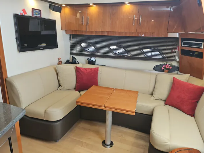  Yacht Photos Pics Luxurious interior of a 2011 Regal 42 Sport Coupe with beige seating and wooden accents.