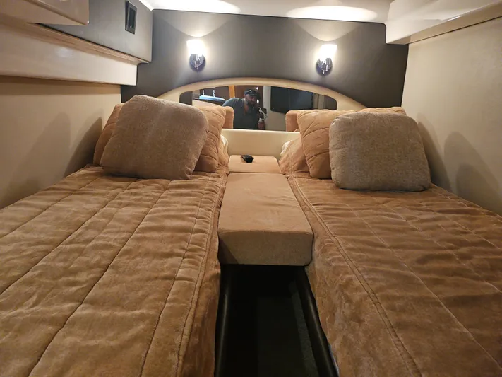  Yacht Photos Pics Interior cabin of 2011 Regal 42 Sport Coupe with twin beds and beige bedding.