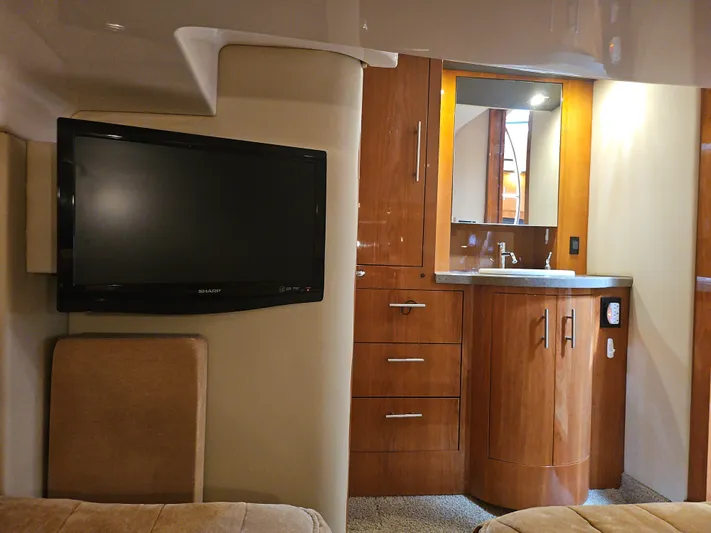  Yacht Photos Pics Interior of 2011 Regal 42 Sport Coupe with TV and wooden cabinetry.