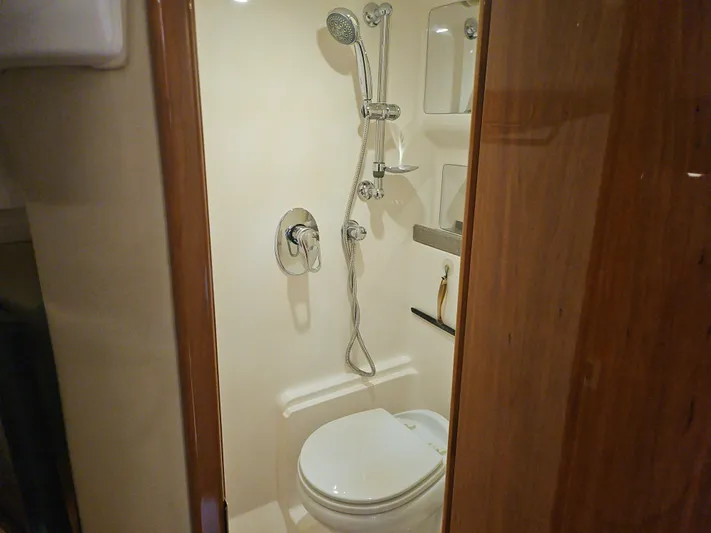 Yacht Photos Pics Bathroom interior of 2011 Regal 42 Sport Coupe yacht, featuring shower and toilet.