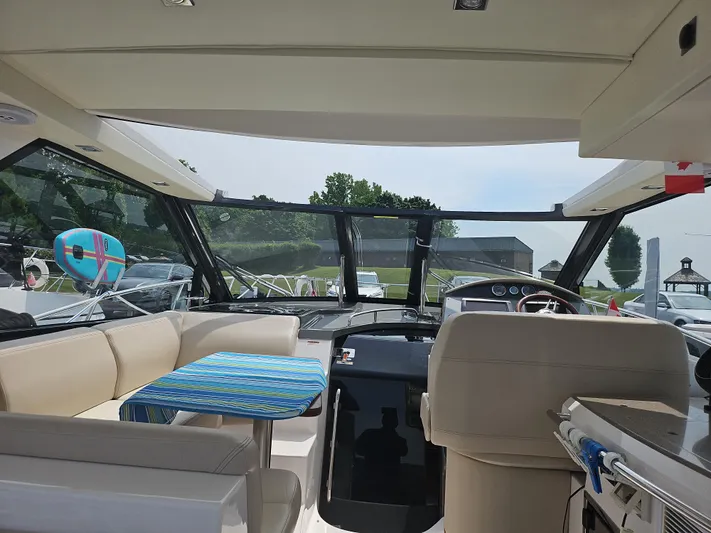  Yacht Photos Pics Interior view of 2011 Regal 42 Sport Coupe yacht with seating and dashboard.