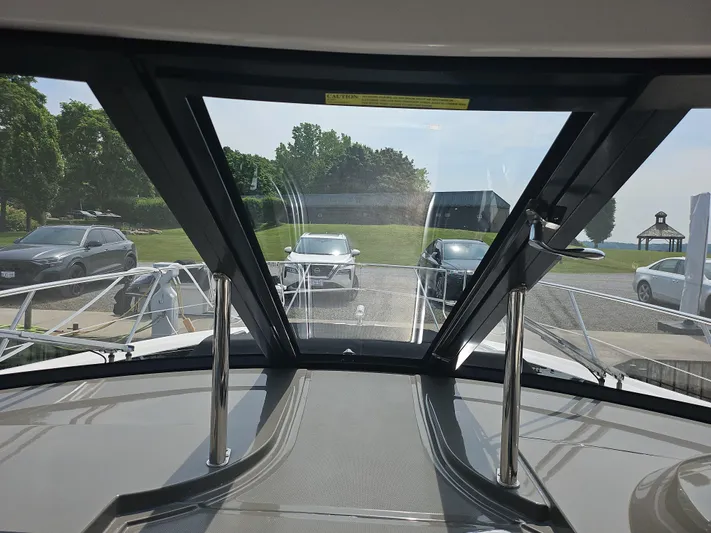  Yacht Photos Pics View from 2011 Regal 42 Sport Coupe yacht, showing docked cars and greenery.