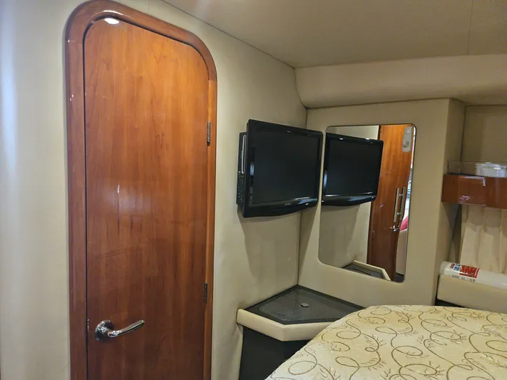  Yacht Photos Pics Interior of 2011 Regal 42 Sport Coupe with wooden door, TV, and mirror.