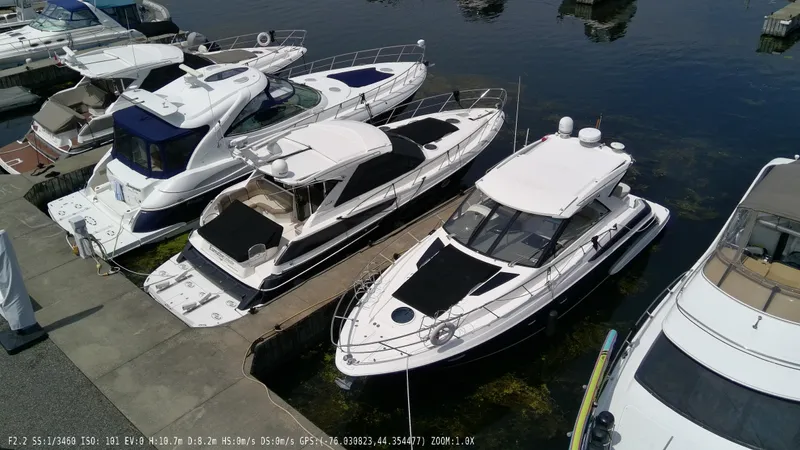  Yacht Photos Pics 2011 Regal 42 Sport Coupe docked among other luxury boats at a marina.