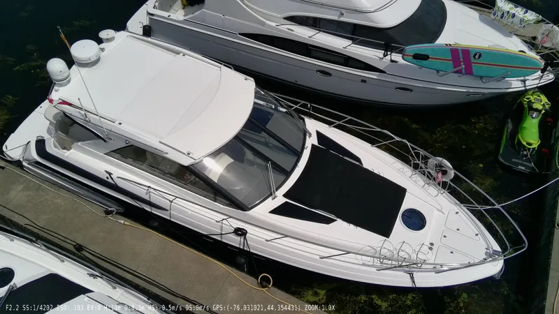  Yacht Photos Pics 2011 Regal 42 Sport Coupe docked alongside other boats.