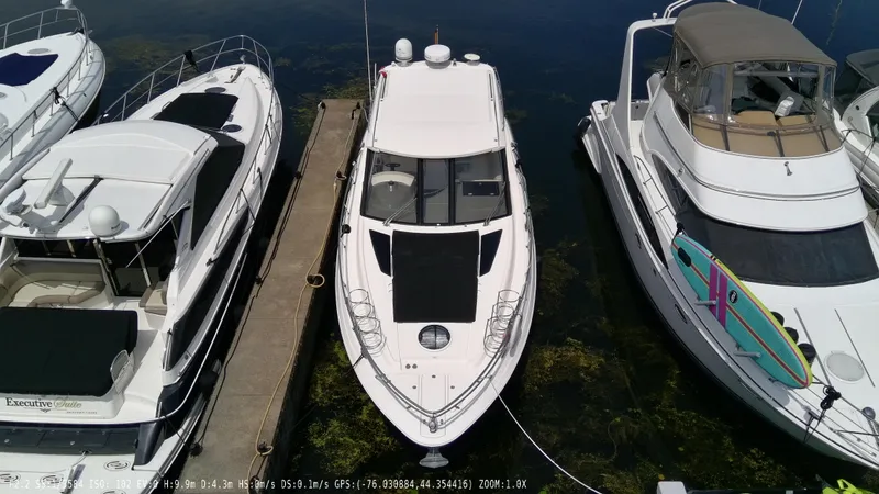  Yacht Photos Pics 2011 Regal 42 Sport Coupe docked between two boats.