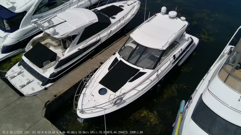  Yacht Photos Pics 2011 Regal 42 Sport Coupe docked among other boats in a marina.