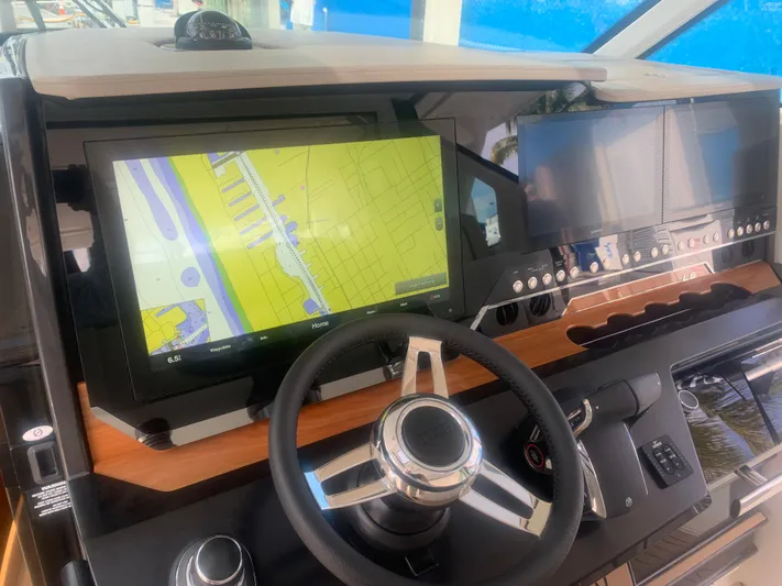  Yacht Photos Pics 2022 Tiara Yachts 48 LS helm with navigation screens and steering wheel.